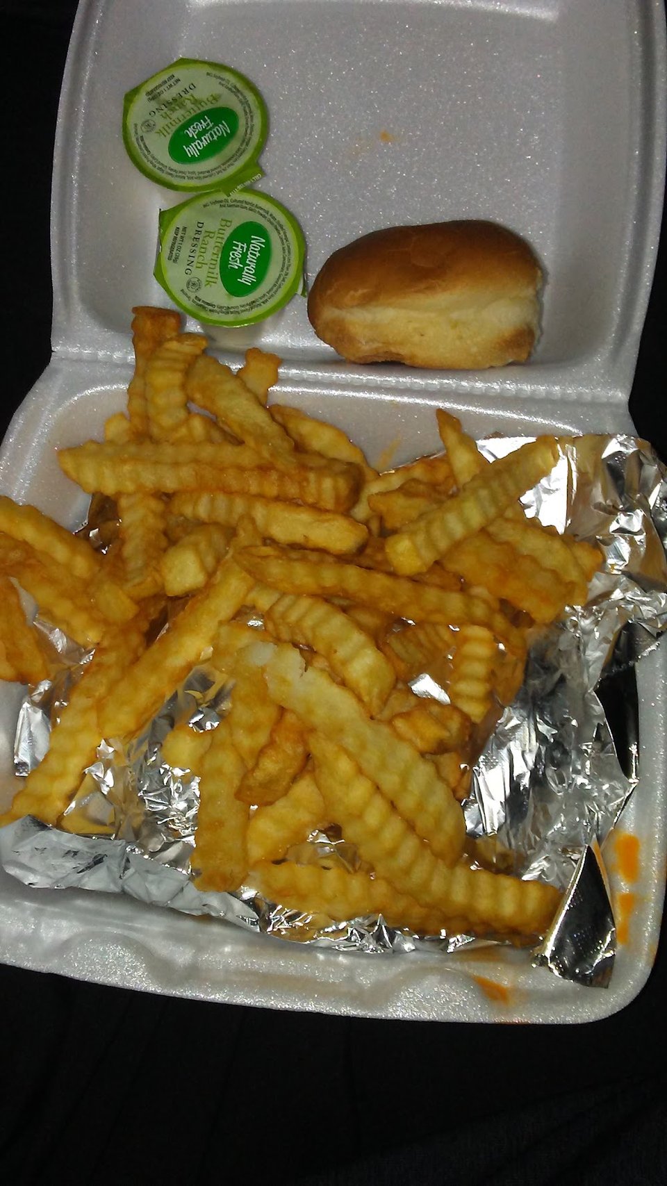 Chicken sandwich with fries and slaw.