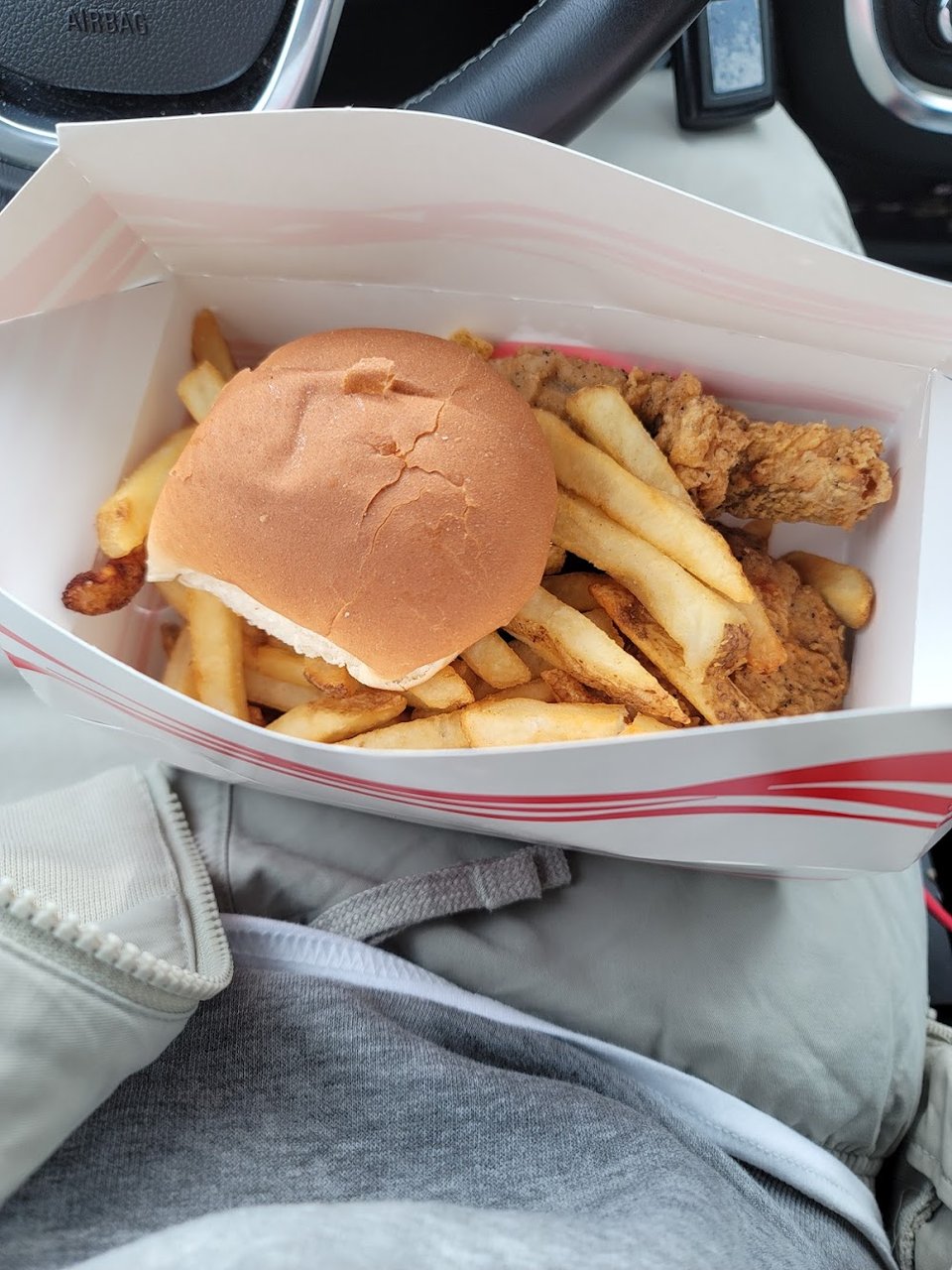 Chicken sandwich with fries and slaw.